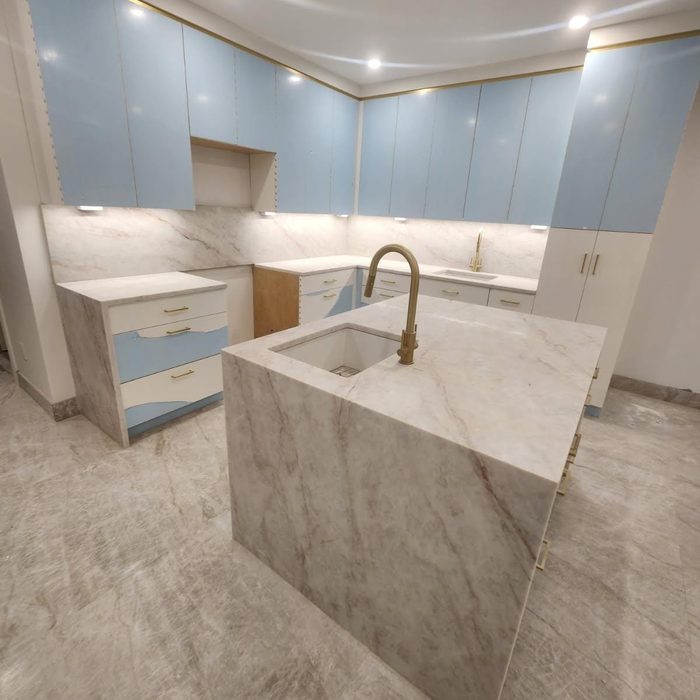 Light blue kitchen with marble waterfall island by CABINX